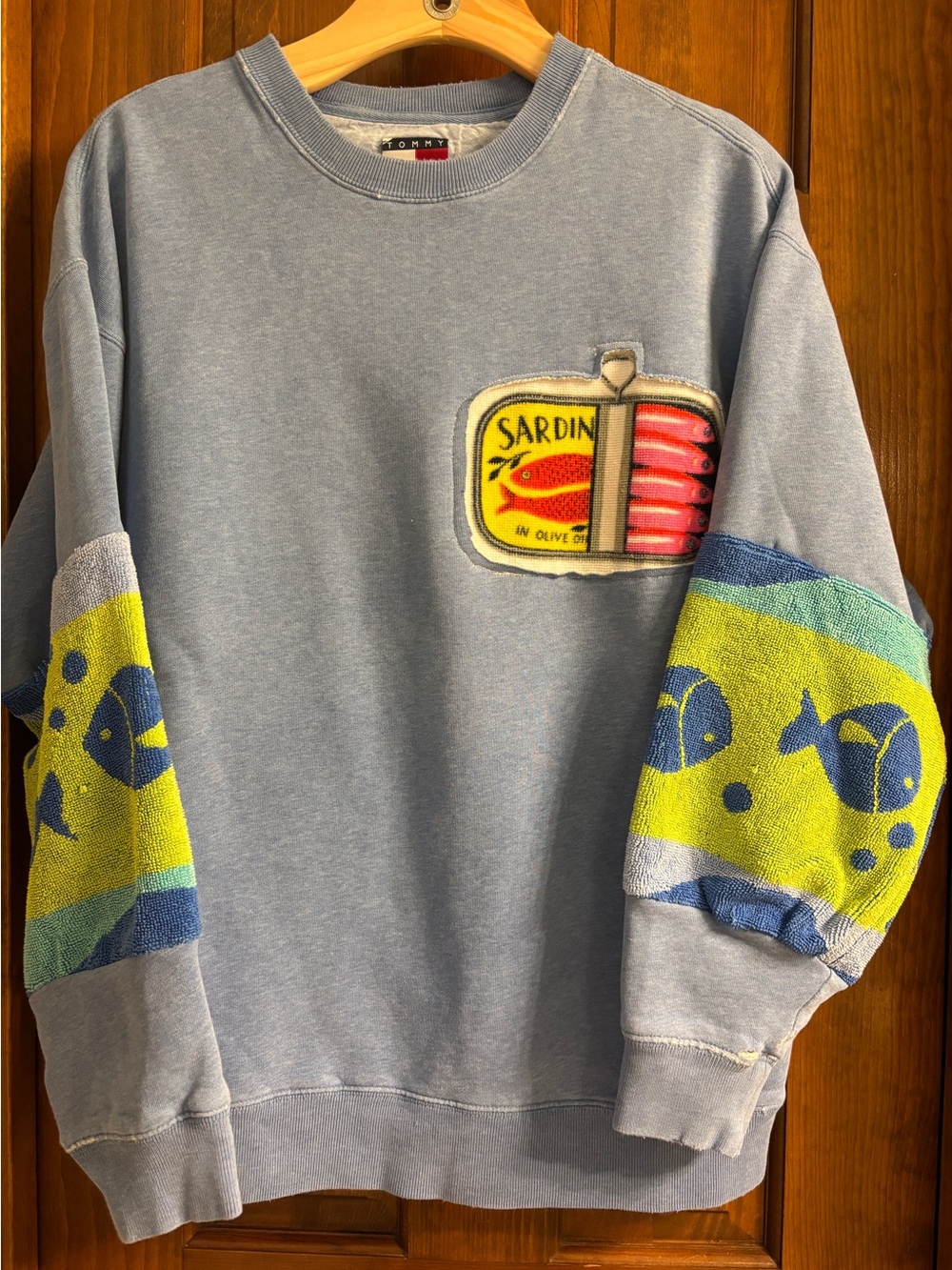 Tommy Hilfiger Light Blue Graphic with upcycled towel sleeves and appliqué.